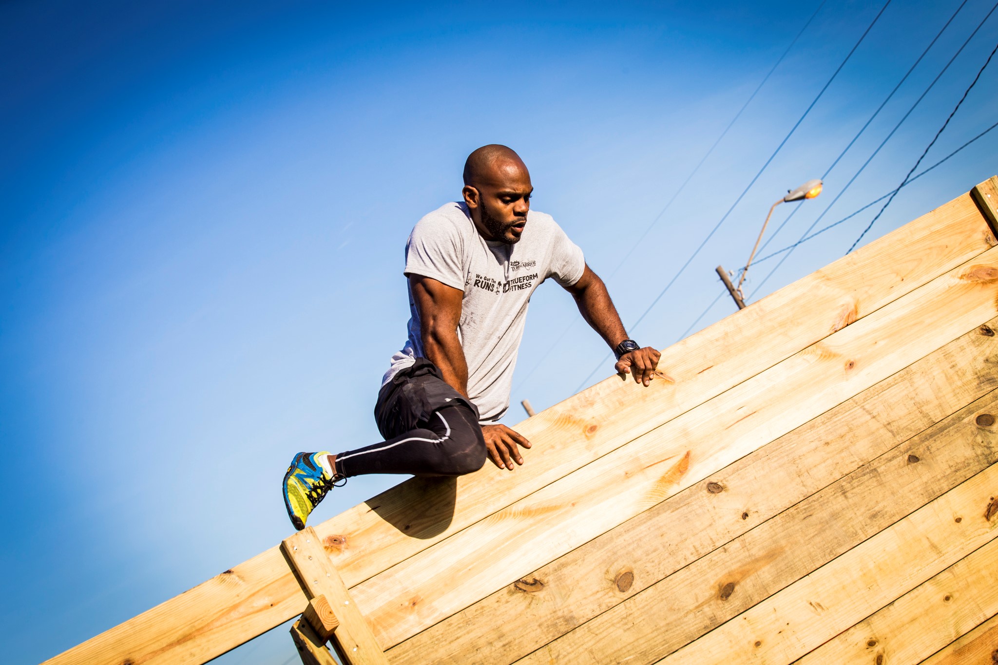 Jair Lyons True Form Fitness demonstrates how to scale a wall obstacle